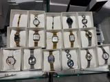 many different watches in a display case on the table