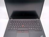the laptop is open on a white surface with a black keyboard
