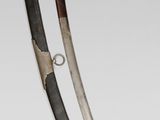 pair of swords with black and gold paint on them on a white surface