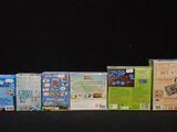 a lot of different types of nintendo wii games on the table