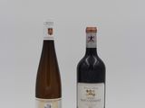 two bottles of wine sitting next to each other on a white surface
