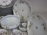 many plates and cups and saucers sitting on a table