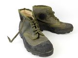 pair of army green boots with laces and rubber soles on a white background