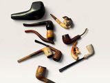 many different types of smoking pipes on a white surface