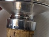 a person holding a wine bottle with a cork stopper