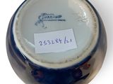 a blue and white vase with a label on it