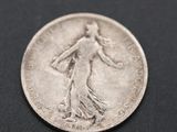 a close up of a silver coin on a black surface