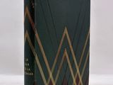 a book with a green cover and gold lines on it