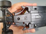 a person holding a remote control car in their hand
