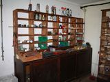 a wooden shelf with many bottles on it in a room