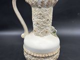 an image of a white pitcher sitting on top of a table