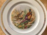 a plate with a picture of two birds on it