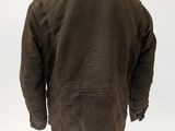 the back view of a brown jacket on a mannequin stand