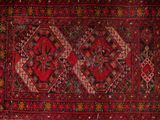 an old persian rug with a red and black design