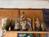 many vases and figurines on a shelf in a room