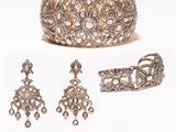 a close up of a bracelet, ring, and earring on a white background