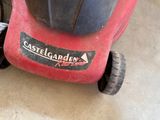 a red lawn mower that is sitting on the floor