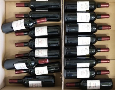 many bottles of wine in a box on the table