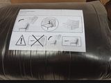 a black pillow that has a sticker on it