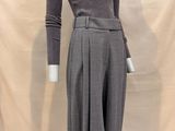 the mannequin is wearing a gray sweater and pants