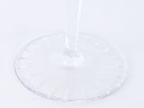 a wine glass with a red liquid inside of it