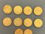 a bunch of gold coins sitting on top of a table