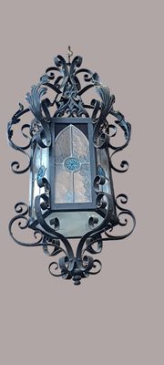 a mirror hanging on the wall with a decorative design