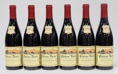 six bottles of red wine are lined up in a row