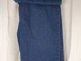 the jeans are hanging on the clothes rack on the bed