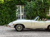 a white convertible car parked in front of a house