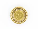a close up of a coin in a gold ring on a white surface