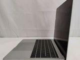 an open laptop computer sitting on top of a white table