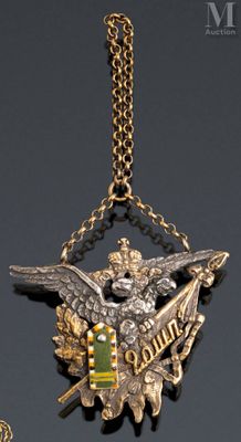 an image of a gold and silver necklace with an eagle on it