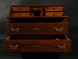 three wooden drawers are stacked on top of each other on a black background