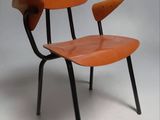 an orange chair with black legs on a white background