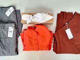 three pairs of pants and a shirt on a table