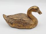 brass duck figurine on a white background