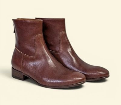 a close up of a pair of brown boots on a white background