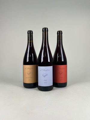 three bottles of wine sitting next to each other on a table