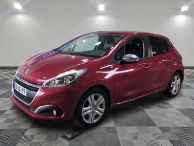 une voiture rouge garée dans un garage au sol en damier