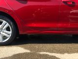 a red car that is parked in a parking lot