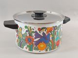 une casserole avec un couvercle orné d'un motif représentant un oiseau