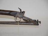an old gun that is sitting on top of a rack
