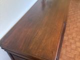 a wooden table with a vase on top of it