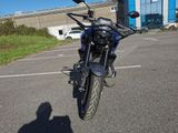 a motorcycle parked in a parking lot with a building in the background