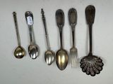 several spoons and spoon spoons are lined up on a white surface