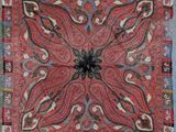 a close up of a red and blue rug on a blue floor