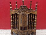 an antique wooden fireplace screen with candles on top of it