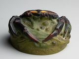 a crab that is sitting on top of a bowl