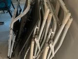 a pile of pipes and chairs in the corner of a room